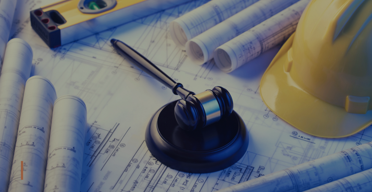 Image of Construction documents, hard hat and gavel.