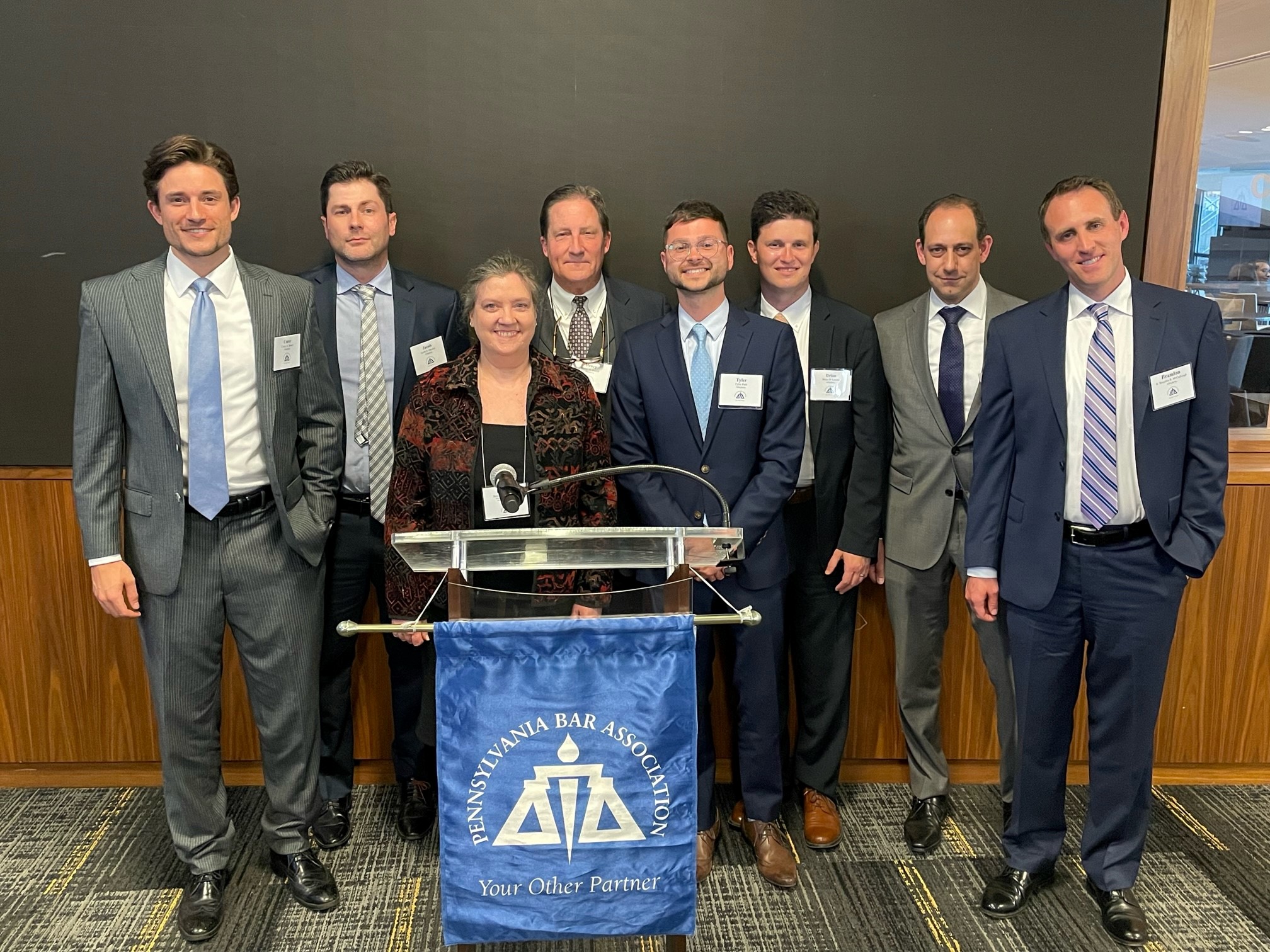 HH Attorneys behind Podium with PBA banner.
